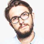 an image of one of the clients, a man with a brown beard wearing an oval glass, has a brown hair, white skin
